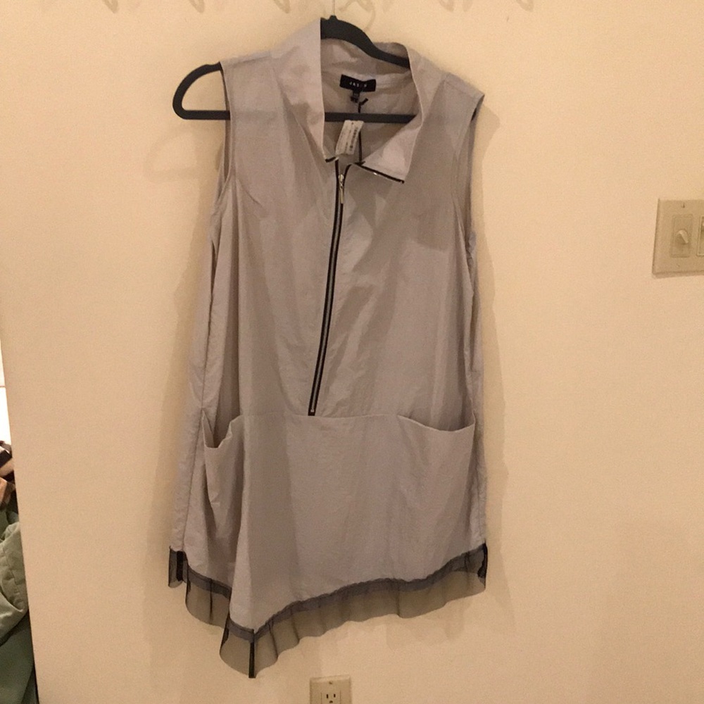 Jason vest with pockets and accent bottom ruffle.